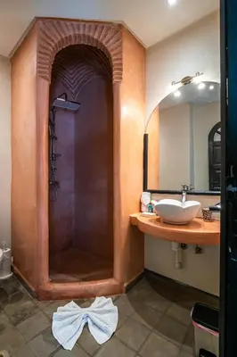 a bathroom with a shower with a sink at Riad Come & Va Medina in Marrakech