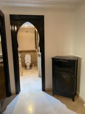 an entrance to a bathroom with a toilet in a room at Studio Salmiya Dune in Marrakech