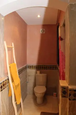 a small bathroom with a toilet in a room at Studio Salmiya Dune in Marrakech