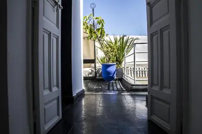 an open door to a balcony with a blue vase at Riad THALGE in Marrakech