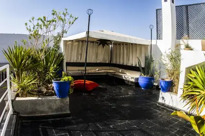 a patio with potted plants on a building at Riad THALGE in Marrakech