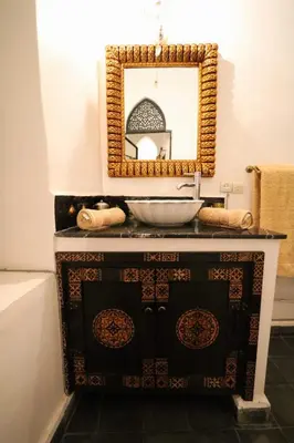 a bathroom with a sink and a mirror at La Voûte Étoilée in Marrakech