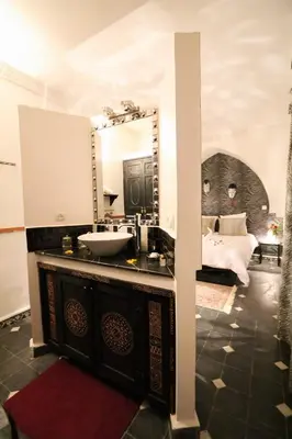 a bathroom with a sink and a mirror at La Voûte Étoilée in Marrakech