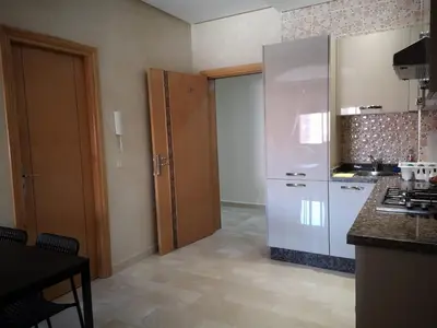 a kitchen with a white refrigerator and a counter at Marrakesh home in Marrakech