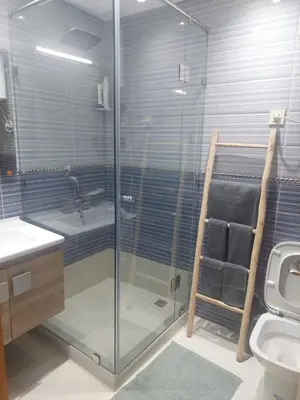 a bathroom with a glass shower and a toilet at Marrakesh home in Marrakech
