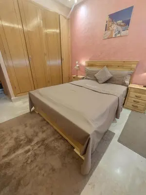 a bedroom with a large bed and a pink wall at Marrakesh home in Marrakech
