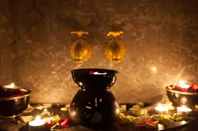 a group of candles and a black vase with lights at Medina Loft & Spa in Marrakech