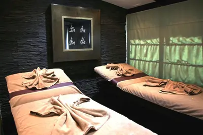 three beds in a room with towels on them at Medina Loft & Spa in Marrakech