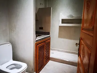 a small bathroom with a toilet and a sink at Riad azra Marrakech in Marrakech
