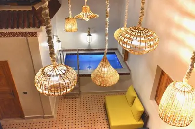 a room with several lights hanging from the ceiling at Riad azra Marrakech in Marrakech
