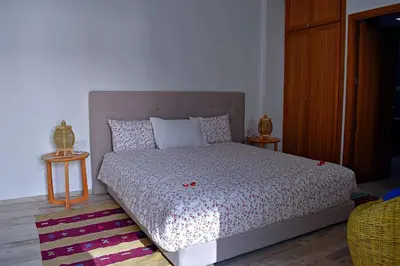 a bedroom with a large bed with two tables at Riad Dar DARRE in Marrakech