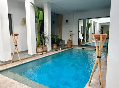 a swimming pool in a house with plants at Riad Dar DARRE in Marrakech