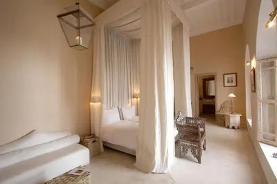 a bedroom with a white bed and a window at Dar Seven in Marrakech