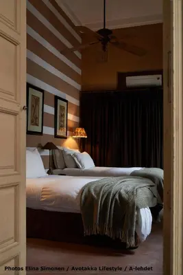 a bedroom with two beds and a ceiling fan at Dar Seven in Marrakech