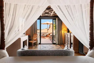 a bedroom with a bed and a view of a patio at Riad Kheirredine in Marrakech