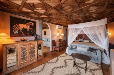 a bedroom with a bed and a couch and a table at Riad Kheirredine in Marrakech
