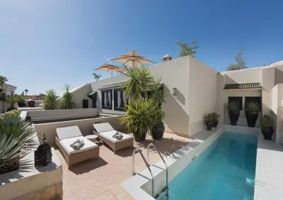 a villa with a swimming pool and a house at Riad Kheirredine in Marrakech