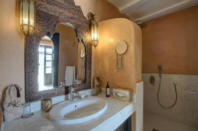 a bathroom with a sink and a mirror at Riad Kheirredine in Marrakech