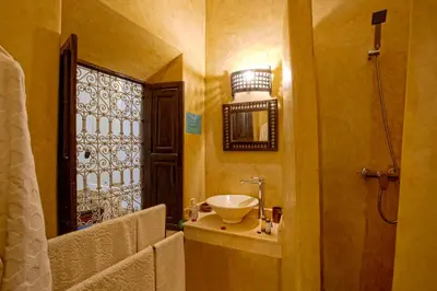 a bathroom with a sink and a window at Riad Al Jana in Marrakech