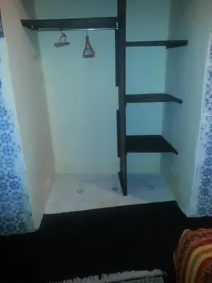 a room with a shelf and a stair case at RIAD DAR KADER chambre saumon in Marrakech