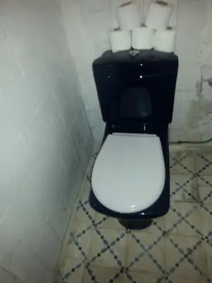 a bathroom with a toilet with four rolls of toilet paper at RIAD DAR KADER chambre saumon in Marrakech
