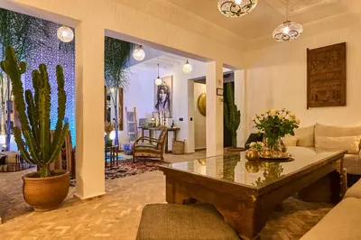 a living room with a table and a couch at Riad Miloud en exclusivité 10 P au cœur de la Médina in Marrakech