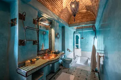 a blue bathroom with a sink and a tub at Riad Adilah Marrakech - by EMERALD STAY in Marrakech
