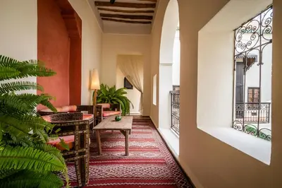 a corridor of a hotel with a table and a couch at Riad Adilah Marrakech - by EMERALD STAY in Marrakech