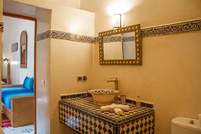 a bathroom with a sink and a mirror at Riad Dar Tamlil in Marrakech