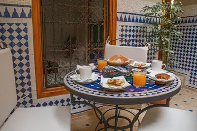 a table with food and drinks on top at Riad Dar Tamlil in Marrakech