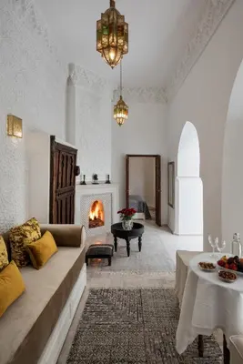 a living room with a couch and a fireplace at Riad Spice by Marrakech Riad in Marrakech