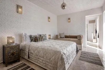 a bedroom with a large bed and a couch at Riad Spice by Marrakech Riad in Marrakech