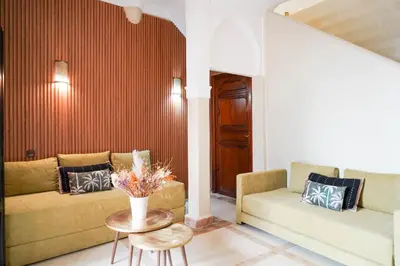 a living room with two couches and a table at Riad NayaNour in Marrakech