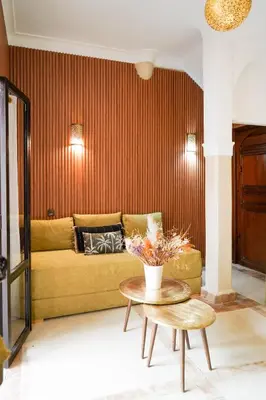 a living room with a couch and a table at Riad NayaNour in Marrakech
