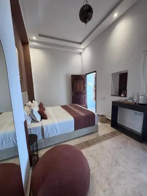 a hotel room with a bed and a desk at Riad NayaNour in Marrakech