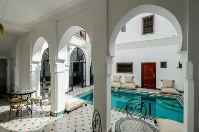 a villa with a swimming pool in a building at Riad NayaNour in Marrakech