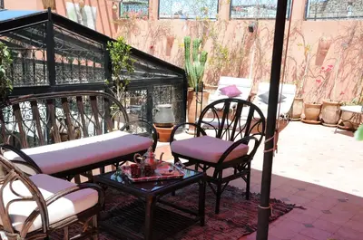 two chairs and a table on a patio at Riad Haraka in Marrakech