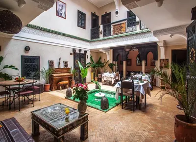 a restaurant with a pool in the middle of a room at Riad Haraka in Marrakech