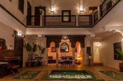a living room with a pool in the middle of a room at Riad Haraka in Marrakech