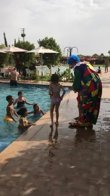 a group of children playing in a swimming pool at Palais Benfatah in Marrakech