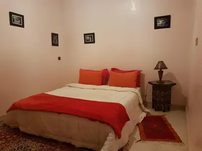 a bedroom with a large bed with red pillows at Zaitouna, Quiet apartment, Modern in Marrakech