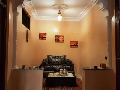 a living room with a couch and a table at Zaitouna, Quiet apartment, Modern in Marrakech