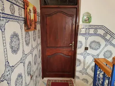 a wooden door in a room with a tile wall at Zaitouna, Quiet apartment, Modern in Marrakech