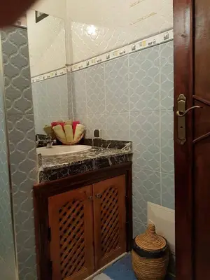 a bathroom with a sink and a counter top at Zwina Appart, A Small, Cozy Family Nest in Marrakech