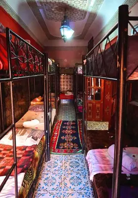 a room with four bunk beds and a hallway at Hostel Marrakech Rouge in Marrakech