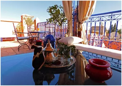 a balcony with a table with vases on it at Riad La Rose D'orient in Marrakech