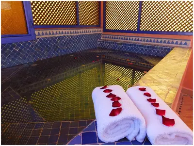 two towels with hearts on them sitting in a tub at Riad La Rose D'orient in Marrakech