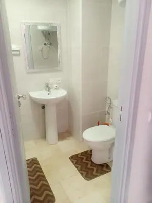 a bathroom with a toilet and a sink at Appartement rouge 6 perso in Marrakech