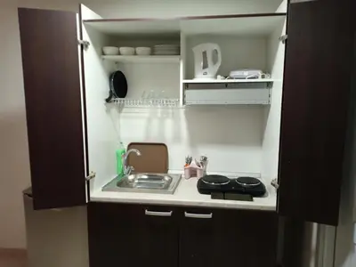 a small kitchen with a sink and a stove at Appartement rouge 6 perso in Marrakech