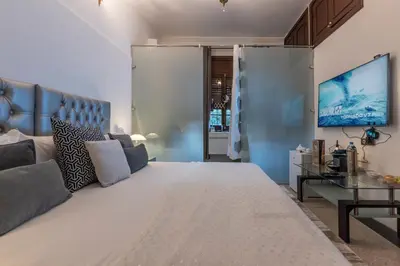 a bedroom with a large white bed and a couch at Villa Soraya Hammam & Jacuzzi in Marrakech